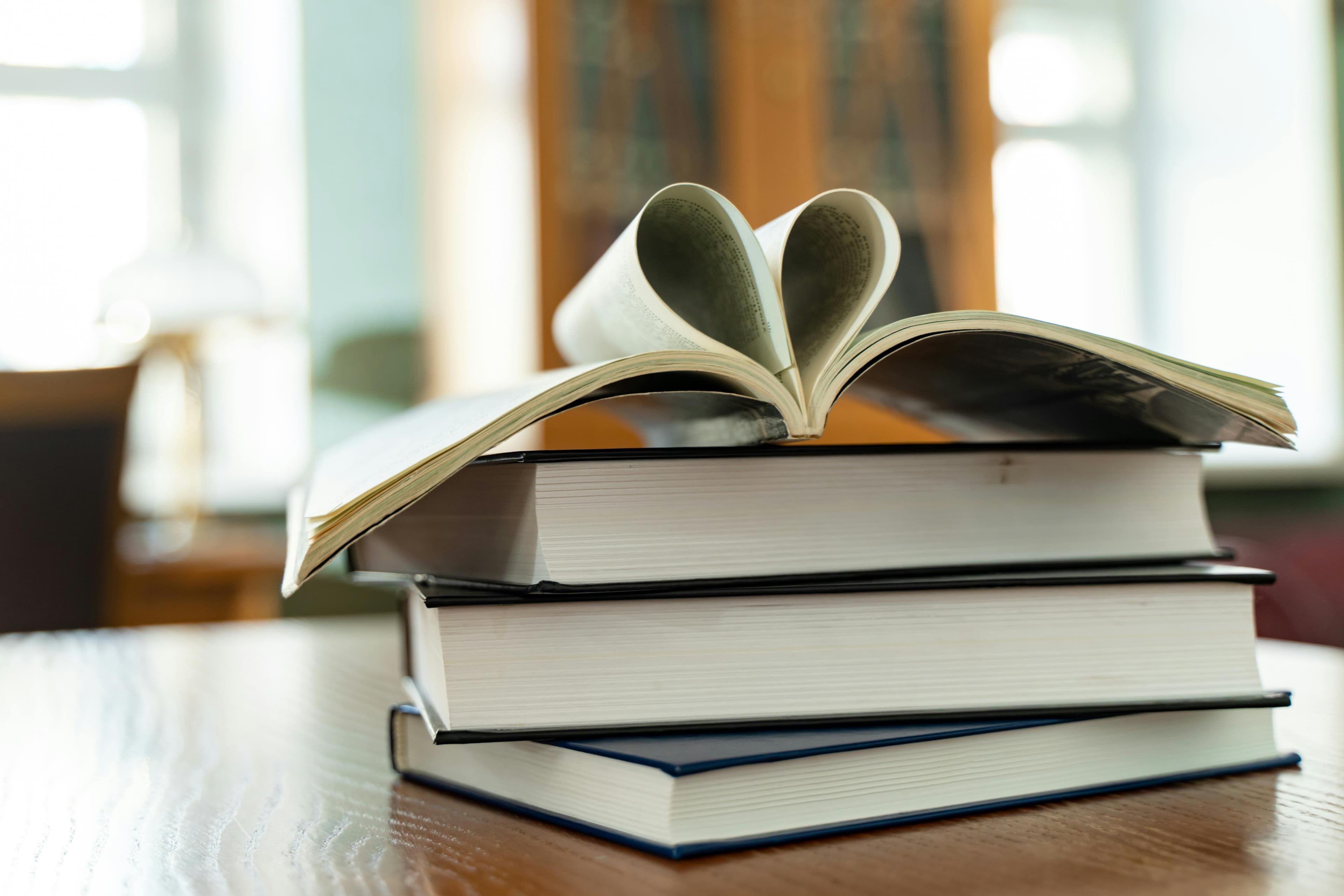 Books forming a heart, promoting a positive and nurturing learning environment in schools